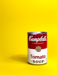 a can of soup on a yellow background