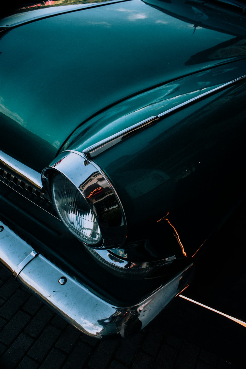 a close up of the front end of a classic car