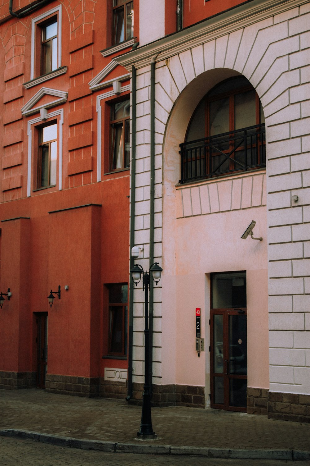 a red and white building with a clock on the front of it