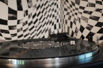 Close-up of a vinyl record spinning on a turntable with colorful psychedelic album art.