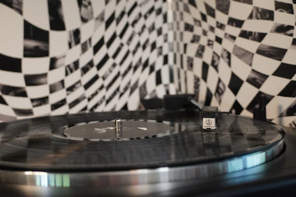 Abstract close-up of vinyl records spinning, with shadows creating an industrial vibe.