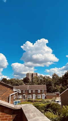 A serene view of Royal Green County’s green lawns and modern homes under a clear blue sky.