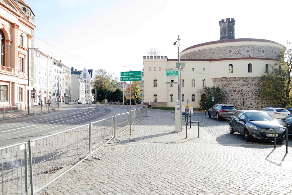 cars parked on the side of the road near a building