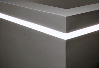 Close-up of a premium linear LED strip integrated seamlessly into a minimalist architectural detail.