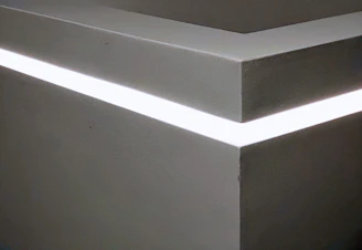 A sleek LED strip softly illuminating a modern living room corner.