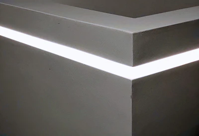 A sleek LED strip softly illuminating a modern living room corner.