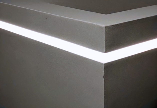 A minimalist room transformed by subtle LED lighting effects.