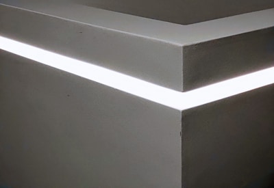 Close-up of a premium linear LED strip integrated seamlessly into a minimalist architectural detail.