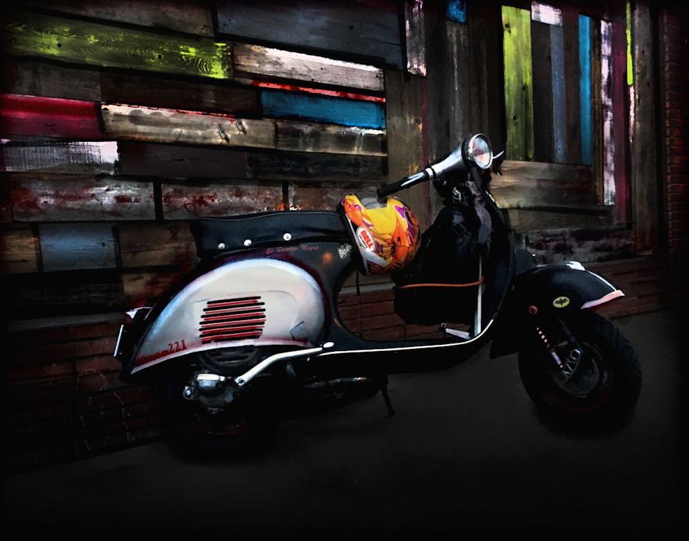 a motor scooter parked in front of a wooden wall