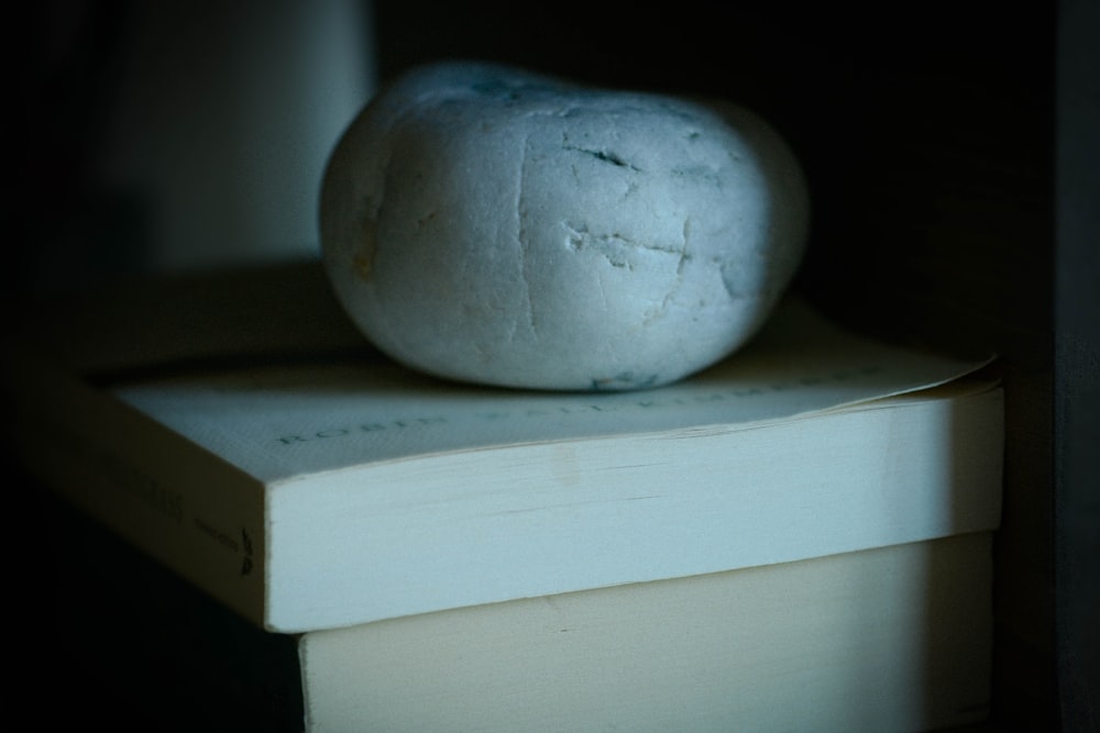 a ball of bread sitting on top of a book