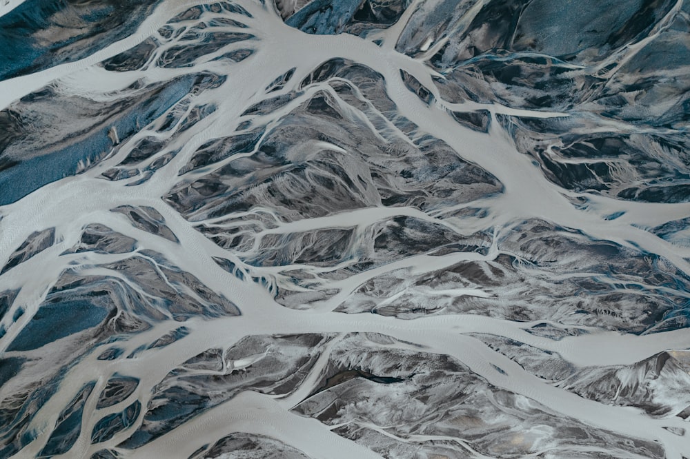 an aerial view of a mountain range covered in snow