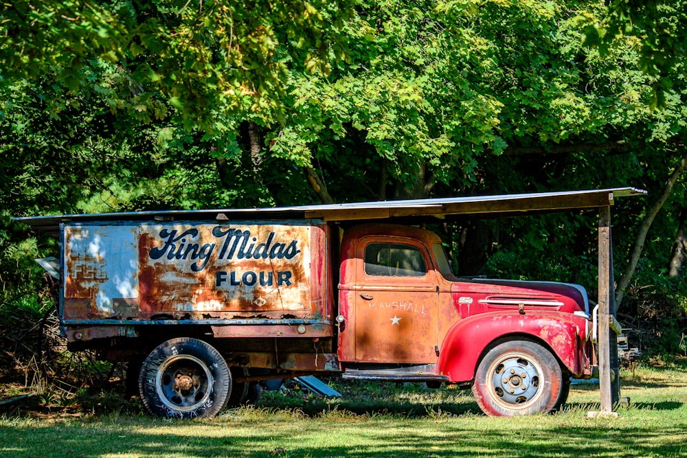 an old truck is parked in the grass