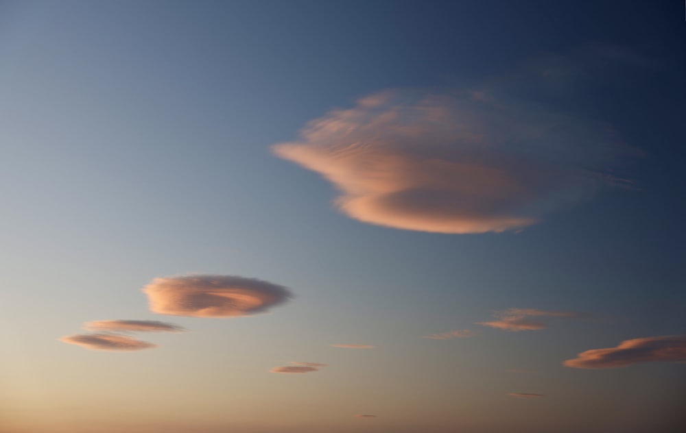 a group of clouds that are in the sky