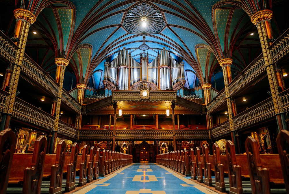 a church with a blue floor and a pipe organ