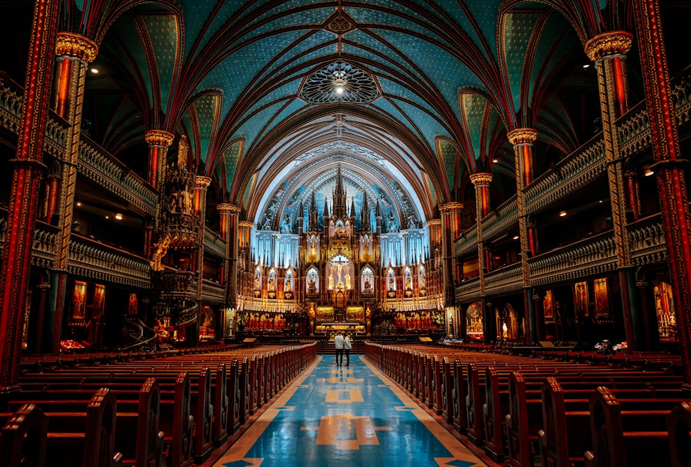 a church with a blue floor and a tall ceiling
