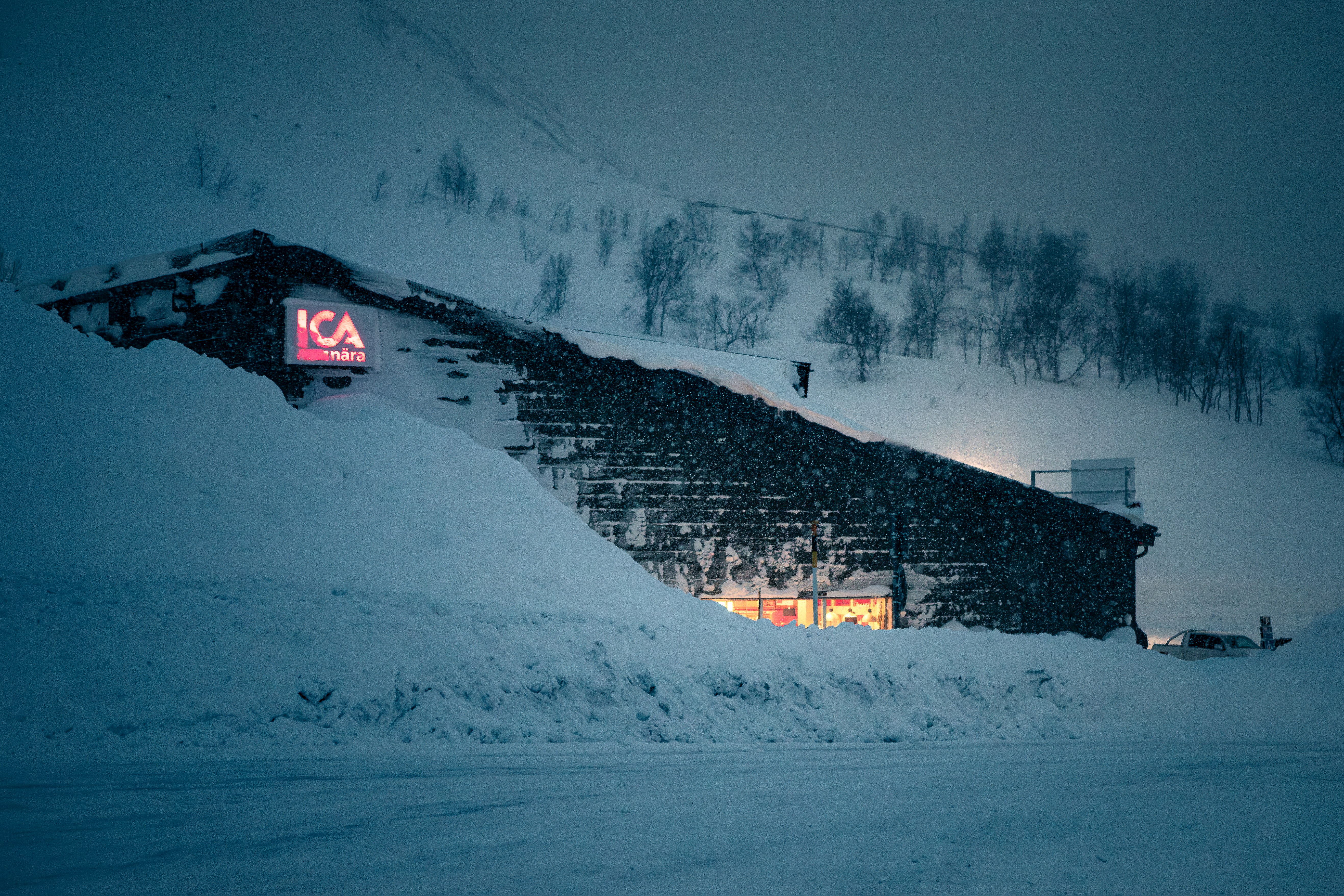 a large pile of snow next to a building