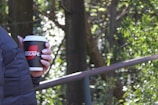 An athlete enjoying a refreshing cup of instant coffee after exercise outdoors.