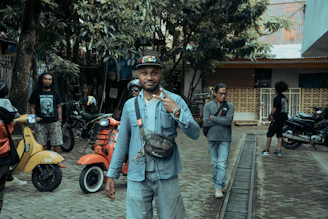 A group of digital nomads laughing on scooters near palm trees at Munchewie.