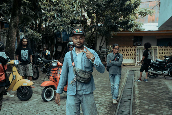 A group of digital nomads laughing on scooters near palm trees at Munchewie.