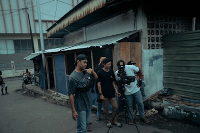 A dynamic film crew setting up cameras on location in an urban Indian street.