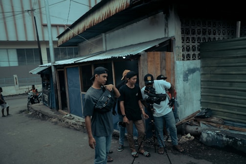 A vibrant film crew setting up cameras and lighting on a colorful Colombian street.
