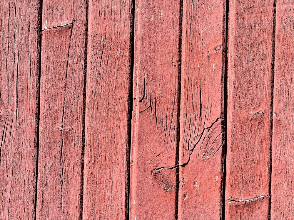 a close up of a red wooden wall