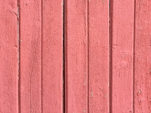 a close up of a red wooden wall