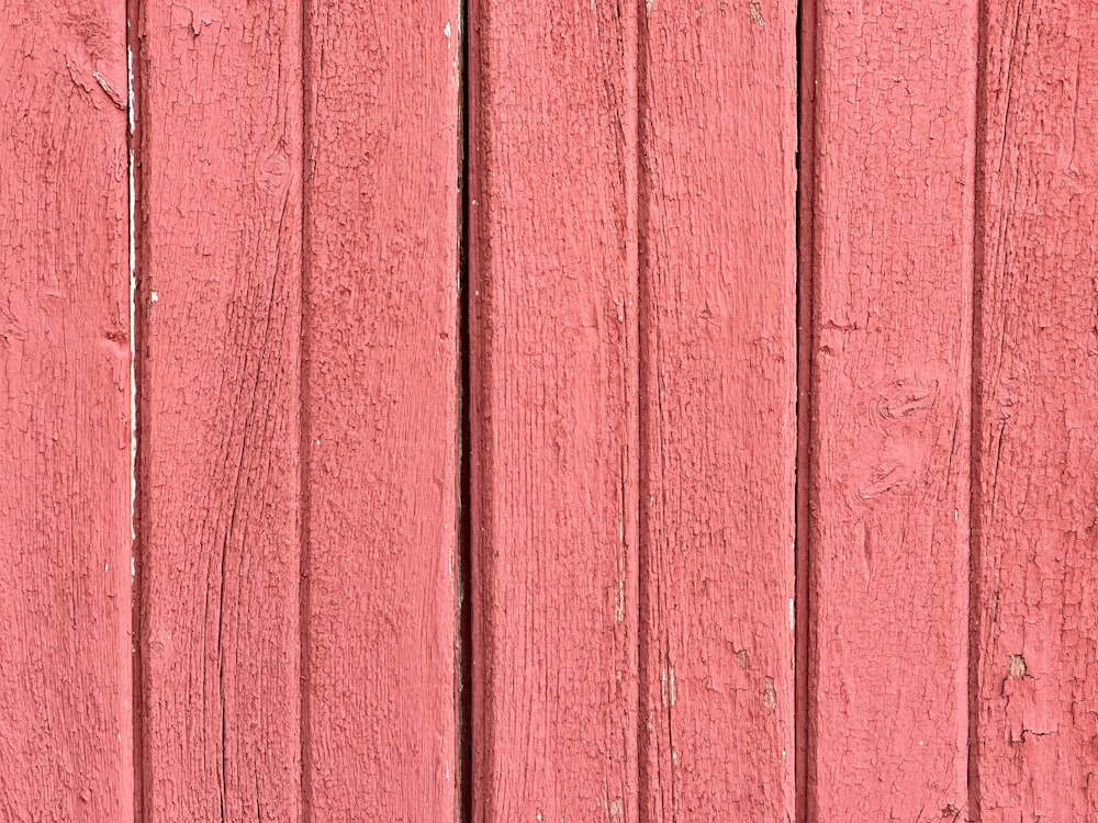 a close up of a red wooden wall