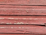 a close up of a red wooden surface