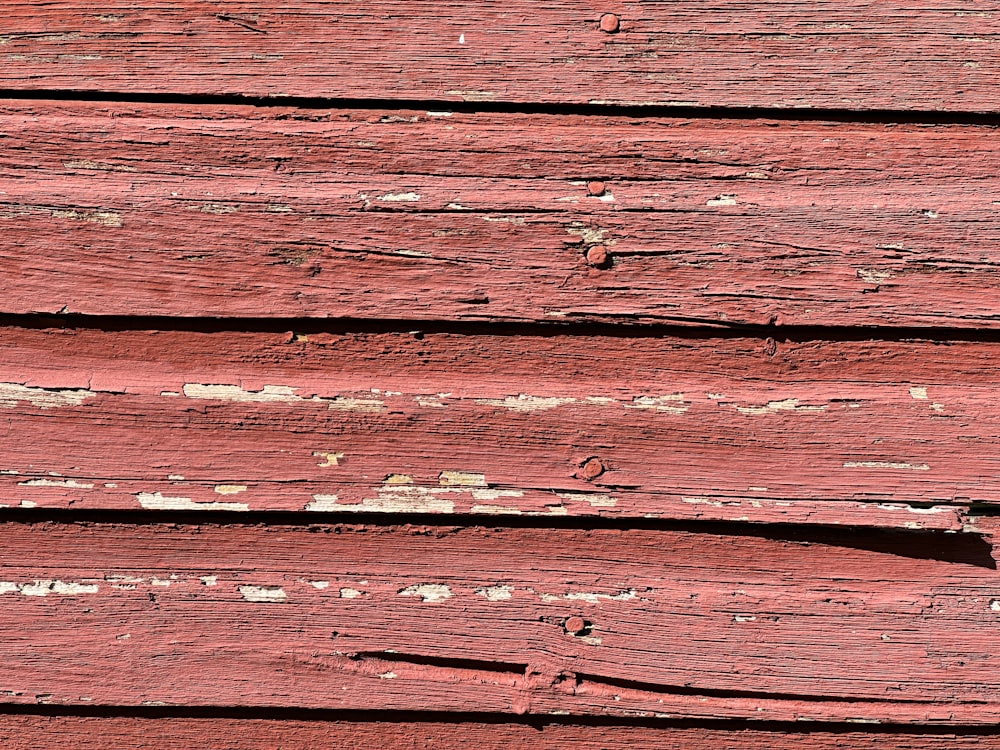 a close up of a red wooden surface