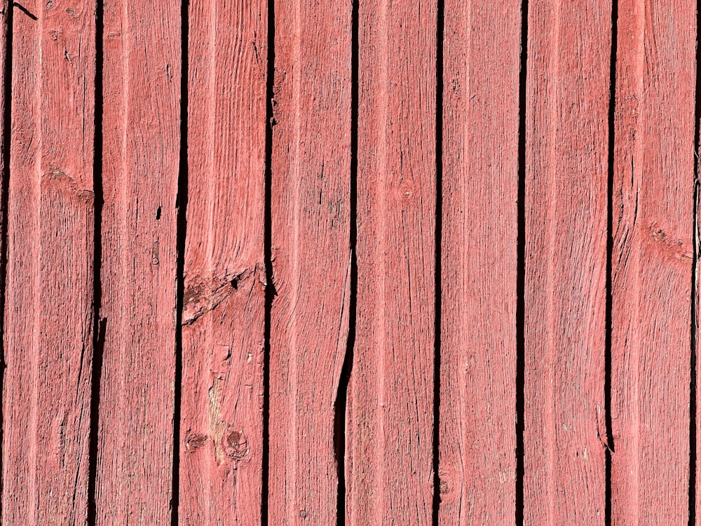 a close up of a red wooden wall