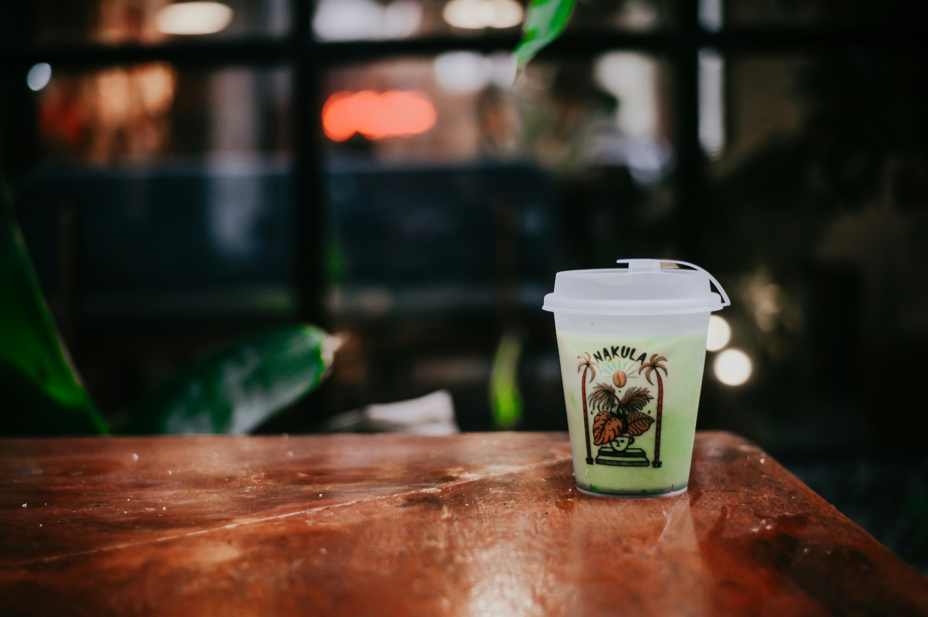 a cup of coffee sitting on top of a wooden table
