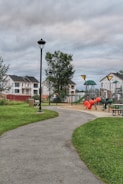 Community park near residential homes with walking paths and playground.
