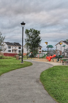 Community park near residential homes with walking paths and playground.