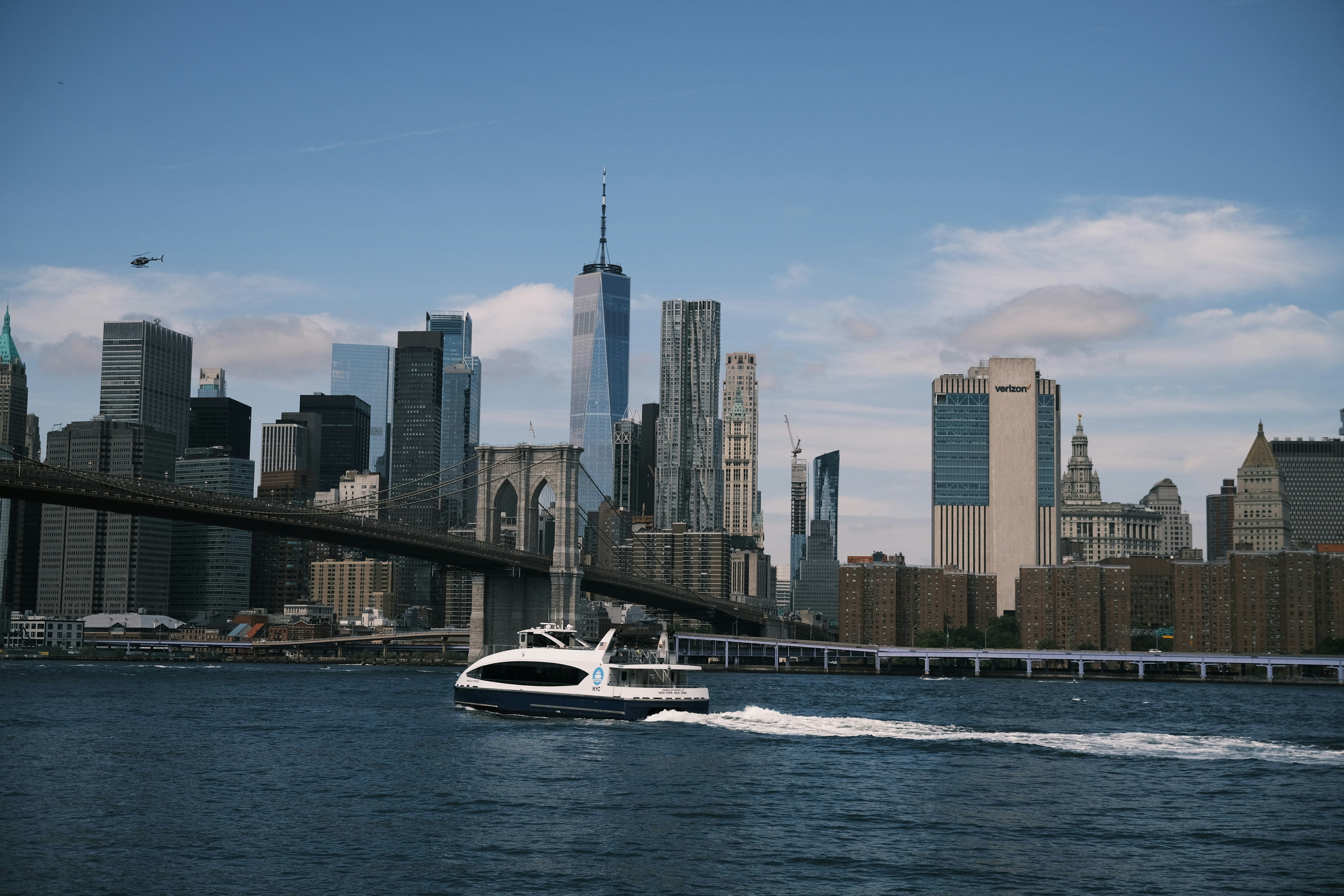 a boat is traveling on the water in front of a large city, 