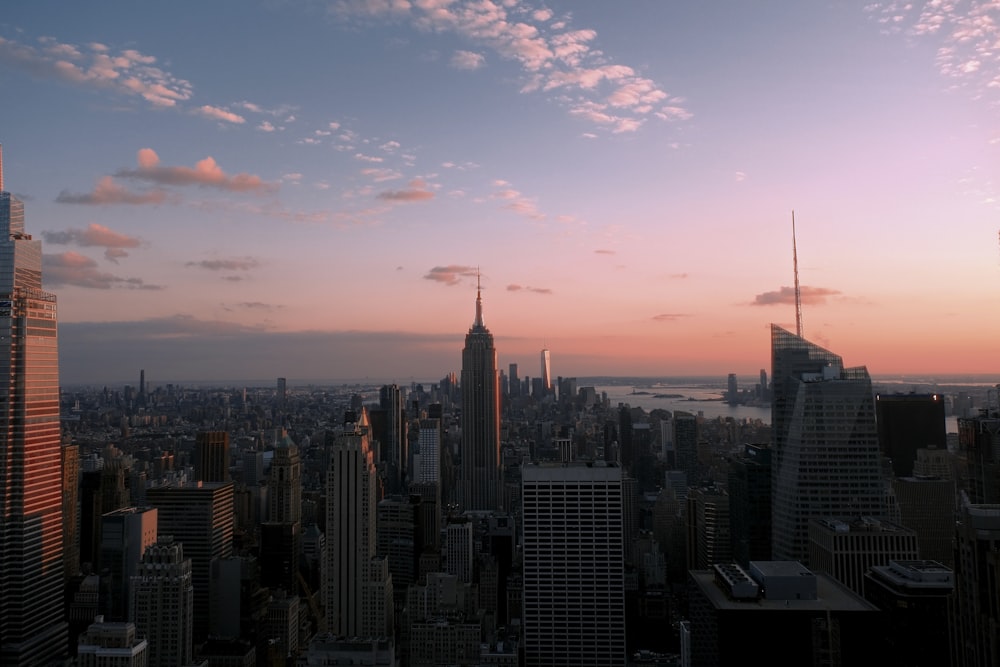 a view of a city at sunset from the top of a building