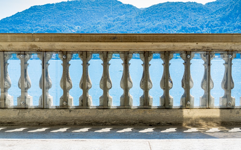 a man sitting on a bench next to a body of water