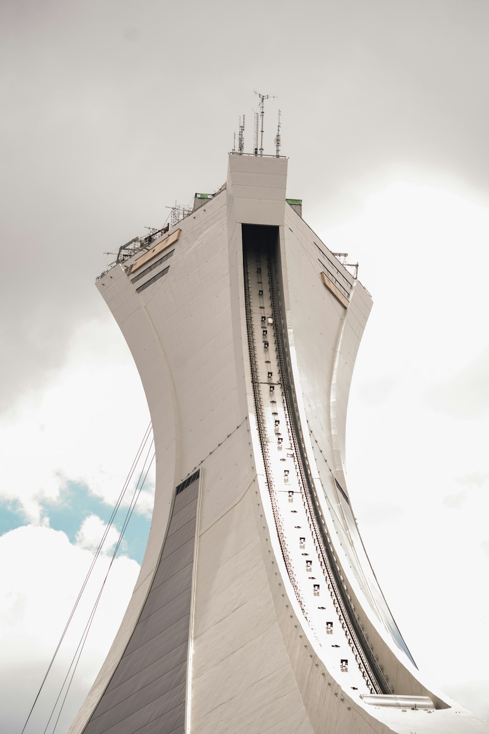 a tall white building with a sky background