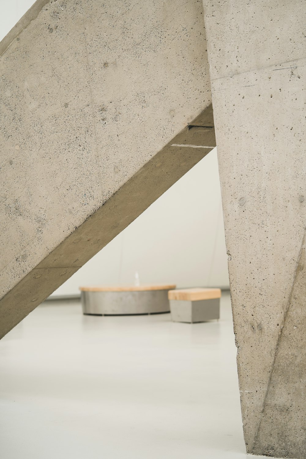a concrete structure with a circular table underneath it