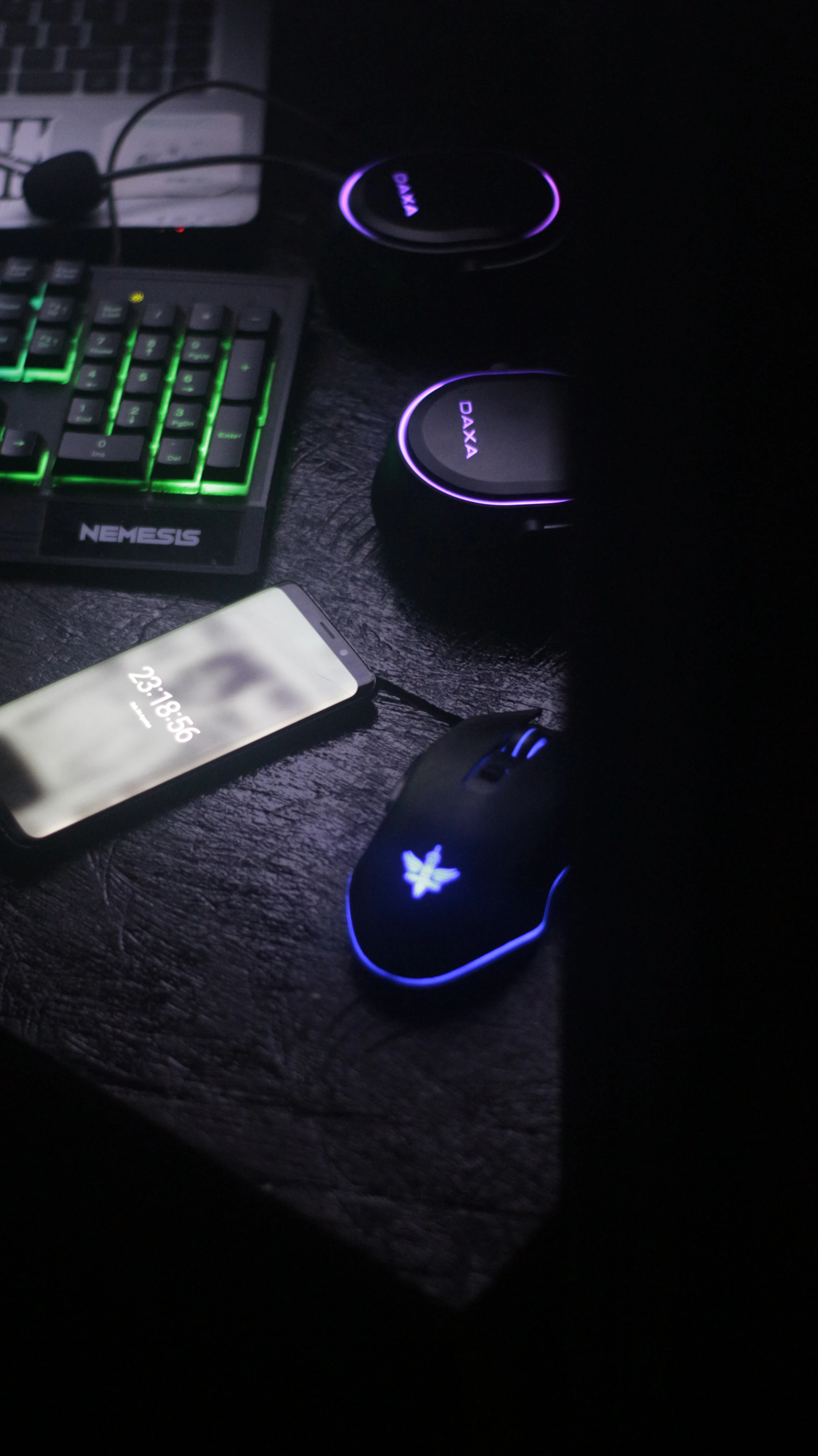 A dynamic tech workspace featuring the latest electronics and gaming gear illuminated by soft white and dark gray lighting.