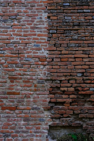 a brick wall with a clock on the side of it