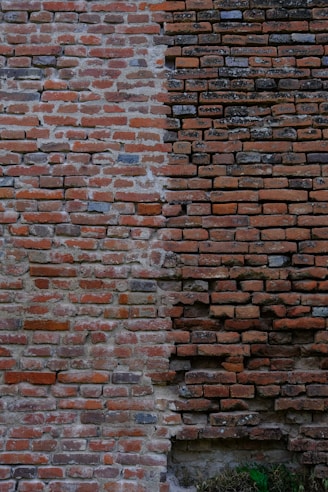a brick wall with a clock on the side of it