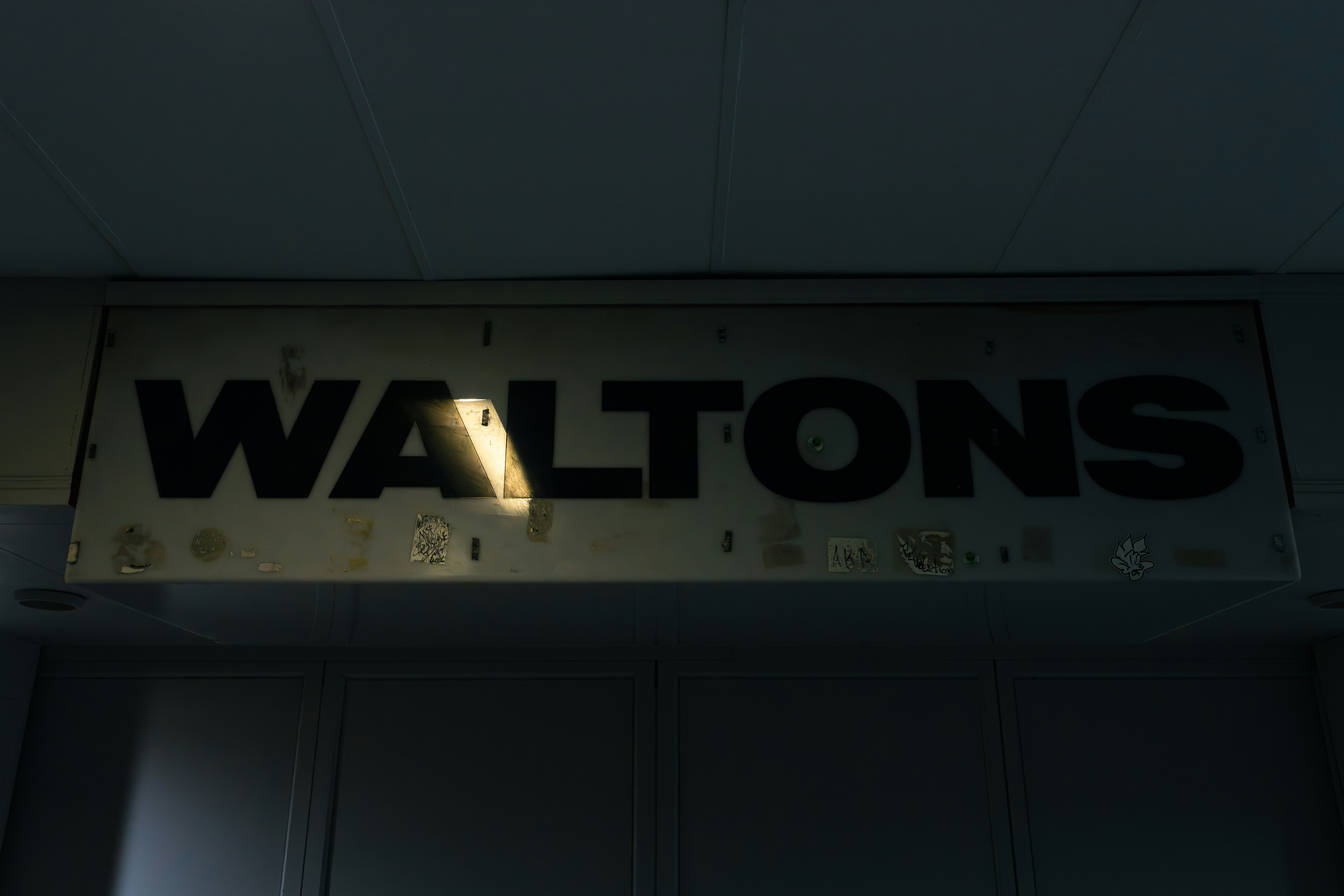 a sign hanging from the ceiling of a building