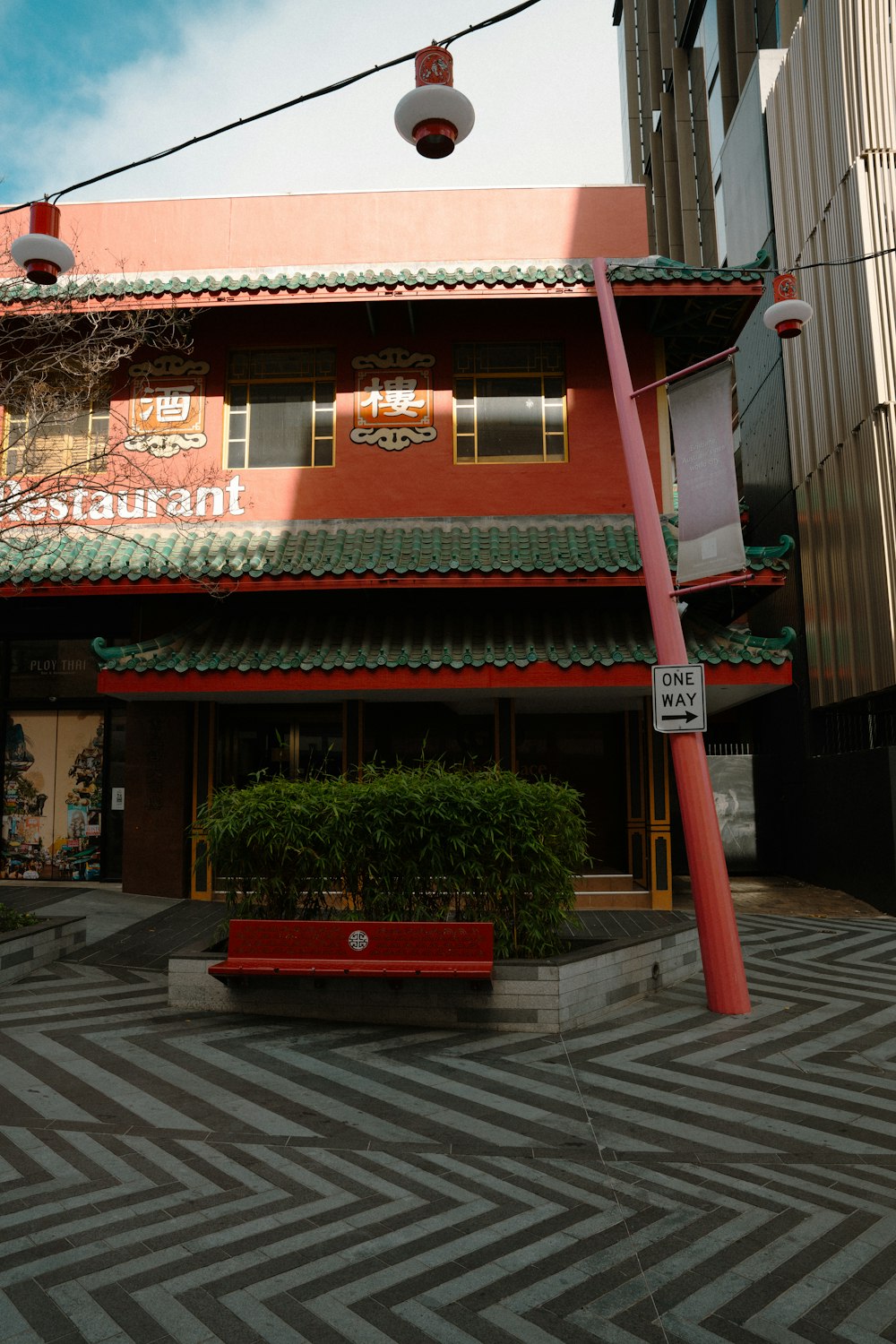 a red bench sitting in front of a building