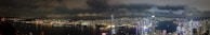 A panoramic view of Sydney cityscape at night, highlighting the skyline.