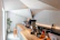 A modern coffee shop interior with minimalist design and customers enjoying their drinks.