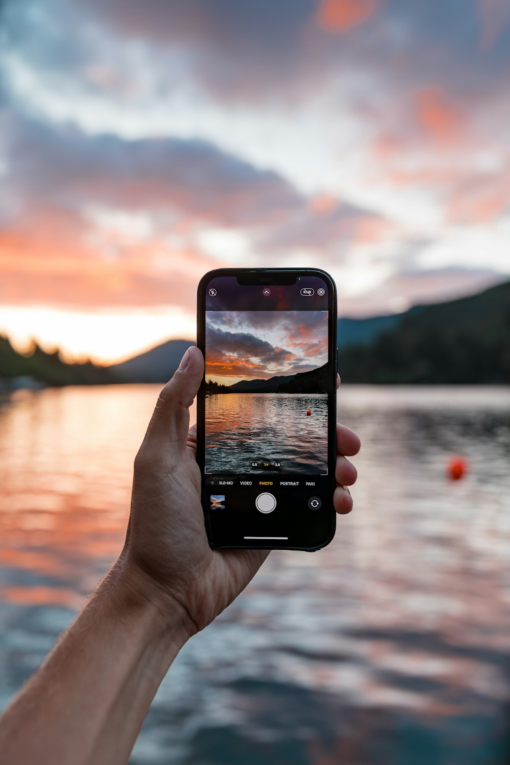 a person holding up a cell phone to take a picture