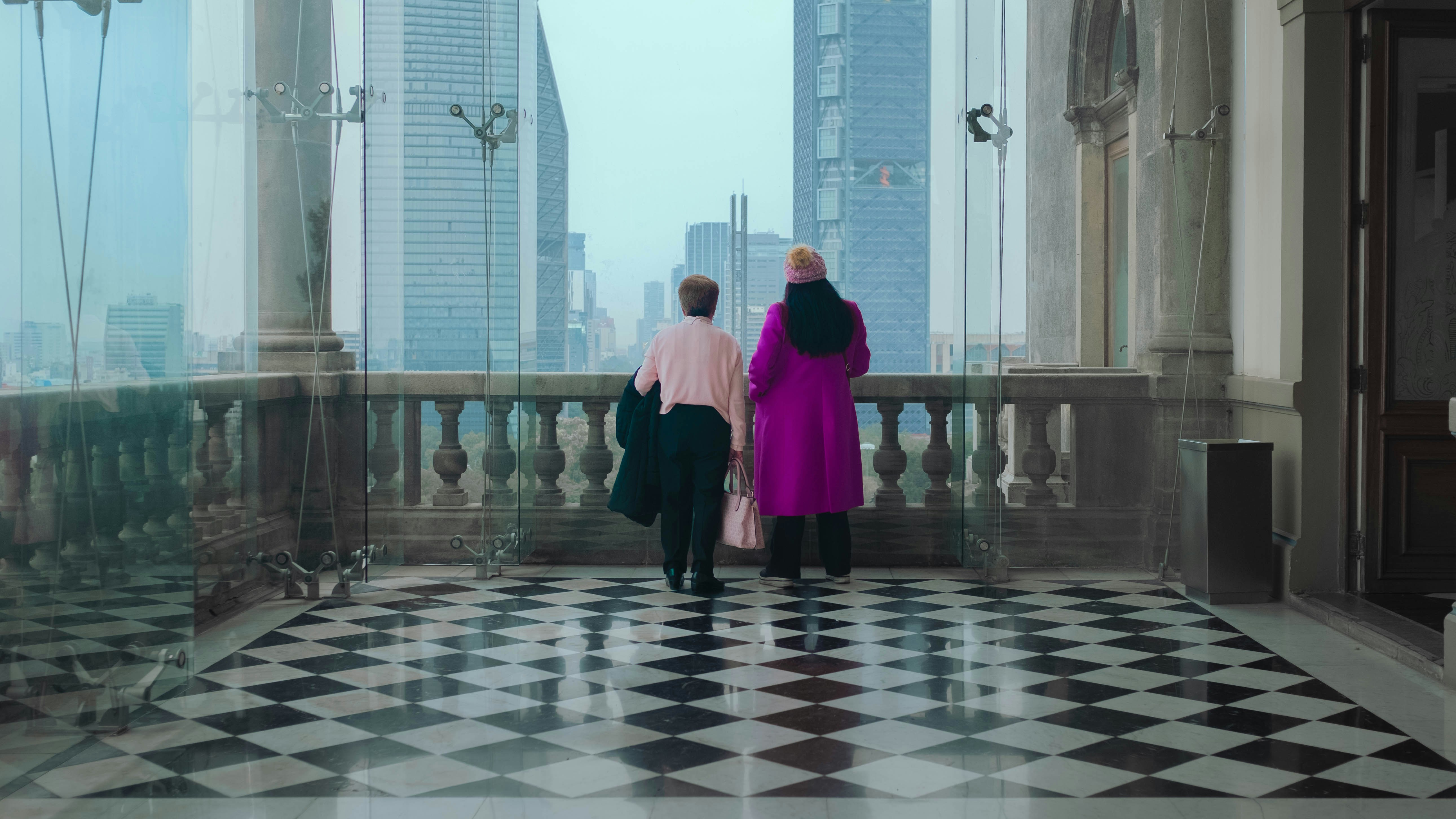 a couple of people that are standing on a balcony