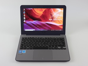 a laptop computer sitting on top of a white table