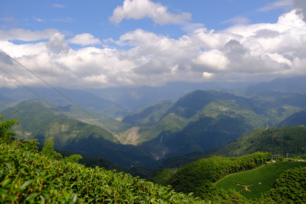 a scenic view of a mountain range with clouds in the sky